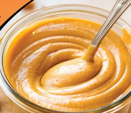 Creamy natural peanut butter in a glass jar